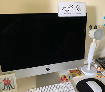 Xander's desk, with Mr Tumble toy and photo of Singing Hands