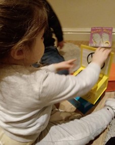 Young girl playing with Makaton Symbol cards